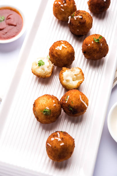 istock Fried potato cheese balls or croquettes with tomato ketchup. Selective focus 881728032