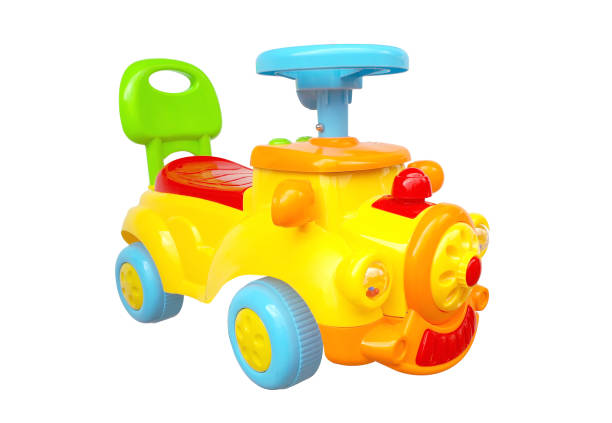 Boy toddler on large electric car close-up and copy space. Baby on truck on street.