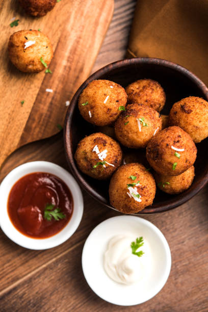 istock Fried potato cheese balls or croquettes with tomato ketchup. Selective focus 881728744