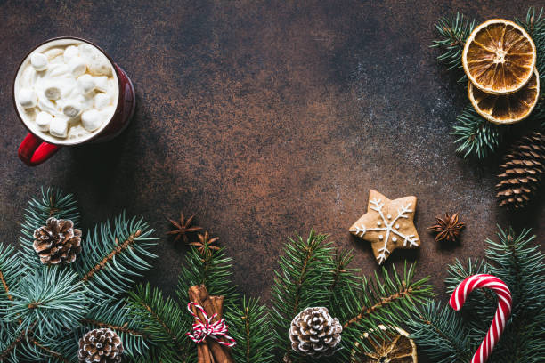 istock Christmas frame with hot chocolate, spices, candy cane, fir tree and gingerbread cookies. 881733752