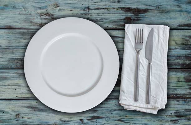 istock Empty plate and cutlery on used look wood 881733756