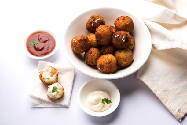 istock Fried potato cheese balls or croquettes with tomato ketchup. Selective focus 881736874