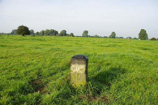 Old stone as a sign in the Field near the Dutch Belgian border.
