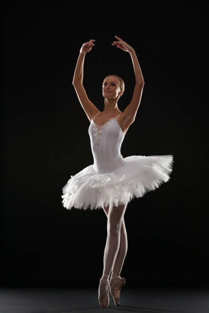 istock Ballerina in studio on a black background 881737006