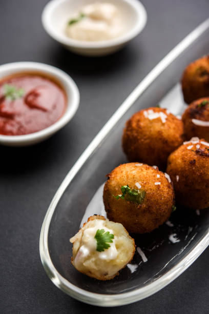 istock Fried potato cheese balls or croquettes with tomato ketchup. Selective focus 881737496
