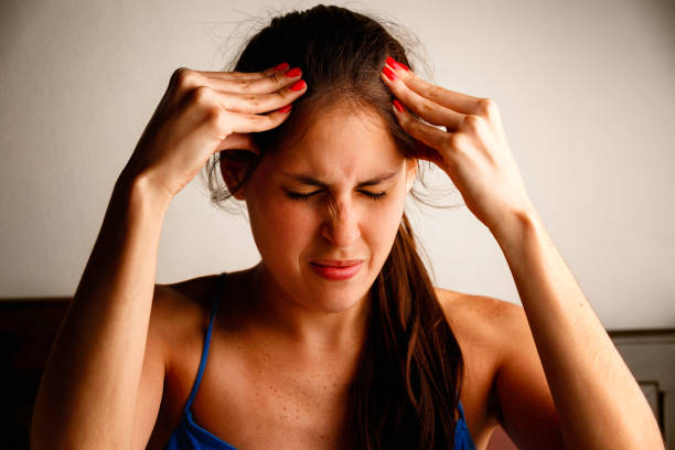 istock Young woman headache pain and hands on head 881740126