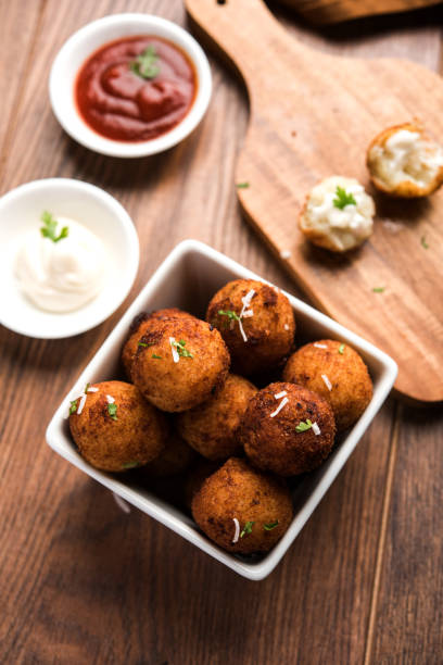 istock Fried potato cheese balls or croquettes with tomato ketchup. Selective focus 881745026