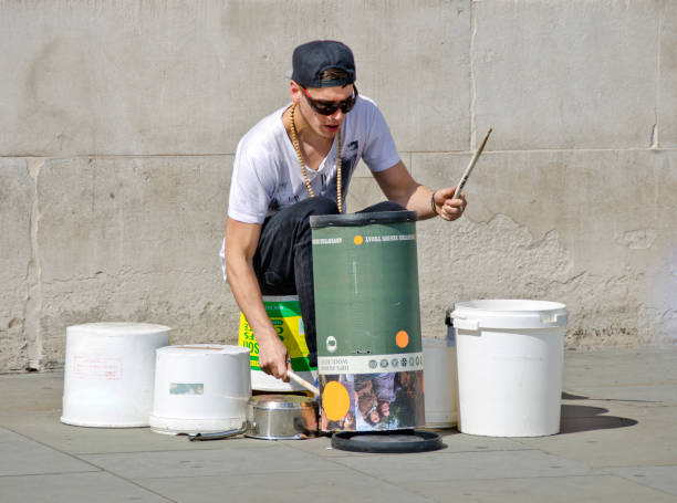 LONDON, UNITED KINGDOM - APRIL 30, 2013: street musician drumming on container made from plastiqe and cardboard