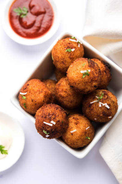 istock Fried potato cheese balls or croquettes with tomato ketchup. Selective focus 881751346