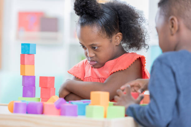 istock African American preschool age girl concentrates while playing with blocks 881751868