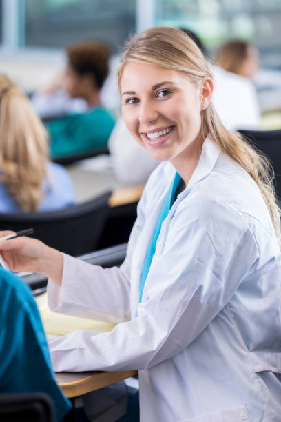 istock Young medical student smile for camera in lecture hall 881752226