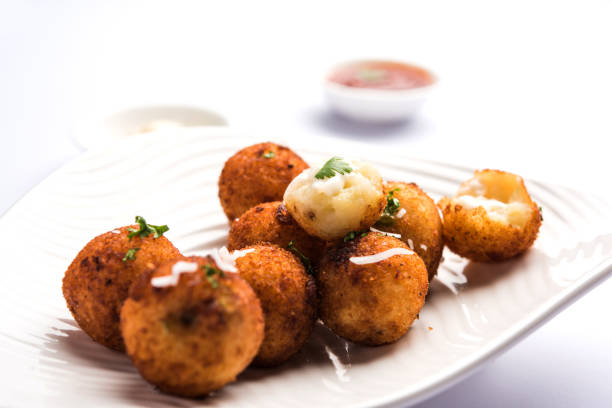 istock Fried potato cheese balls or croquettes with tomato ketchup. Selective focus 881753122