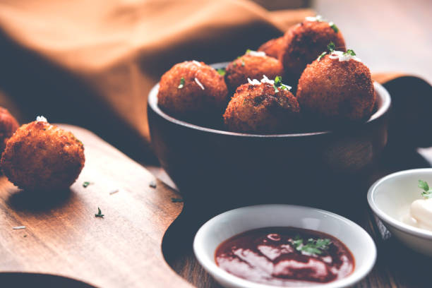 istock Fried potato cheese balls or croquettes with tomato ketchup. Selective focus 881758046