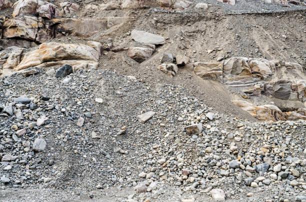 Layered rock face, gravel and sand