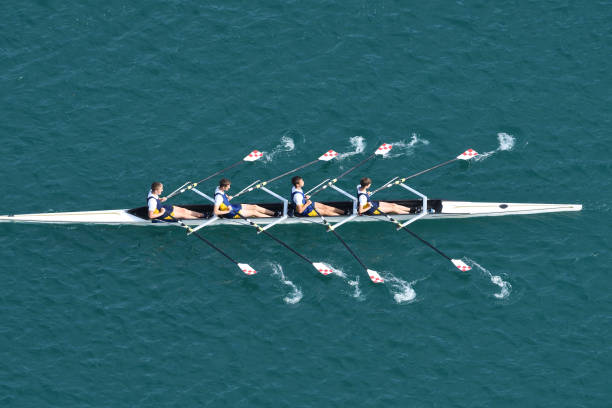 Male Quadruple Scull Rowing Team At the Race, Lake Bled, Slovenia Upper view of quadruple scull rowing team during the race, Lake Bled, Slovenia rowboat stock pictures, royalty-free photos & images