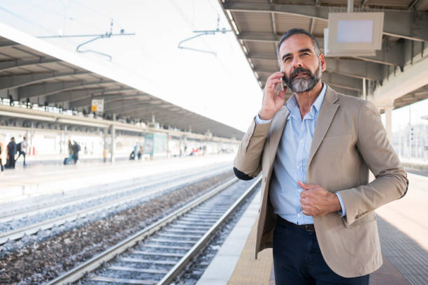 istock Businessman at train station 881768850