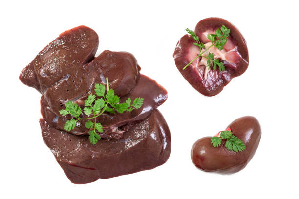 collection of raw lamb offal kidney, liver, heart a white background stock photo