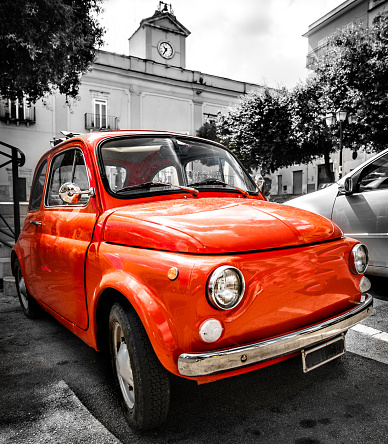 vintage red italian car old selective color black and white italy town