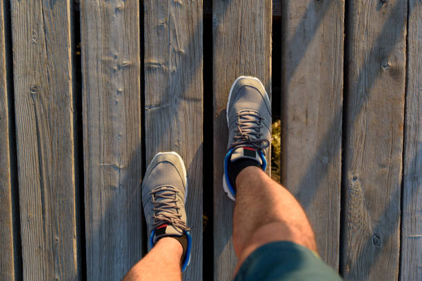 istock Man sport shoe on wooden floor 881780996