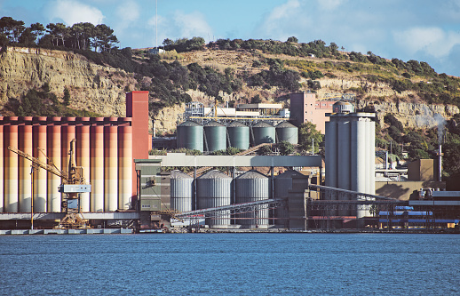 Industrial terminal with silos near the river.