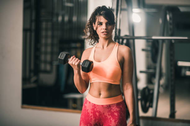 istock Woman holding a hand weight 881789006