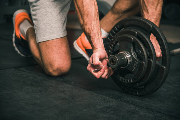 istock Close-up shot of a man setting up the weights 881793574