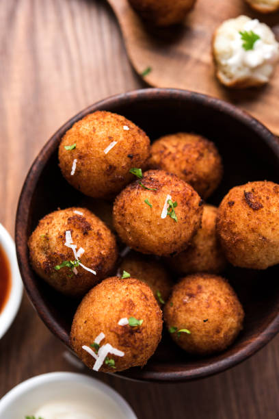 istock Fried potato cheese balls or croquettes with tomato ketchup. Selective focus 881793836