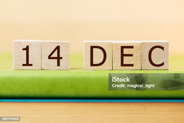 Wooden Cube Shape Calendar For Dec 14 On Green Book Table Stock Photo - Download Image Now