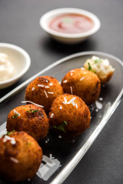 istock Fried potato cheese balls or croquettes with tomato ketchup. Selective focus 881796410