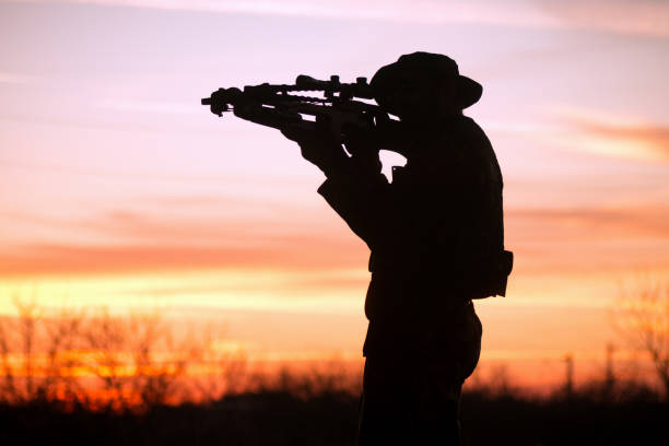istock man with cross-bow silhouette 881813726