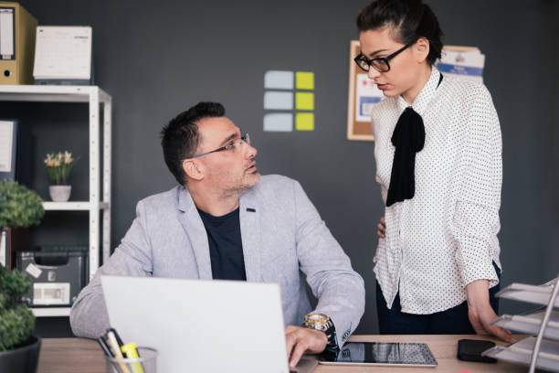 istock Business man working with colleague standing by 881814858