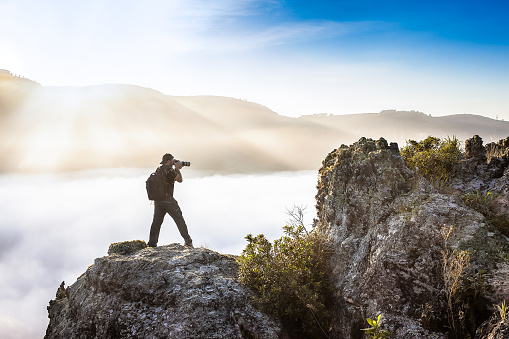 Man with backpack shooting above the clouds - Guartela Canyon - Tibagi/ PR - Brazil
