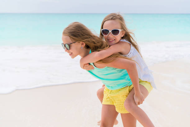 istock Kids have fun on the white sandy beach outdoors 881817626