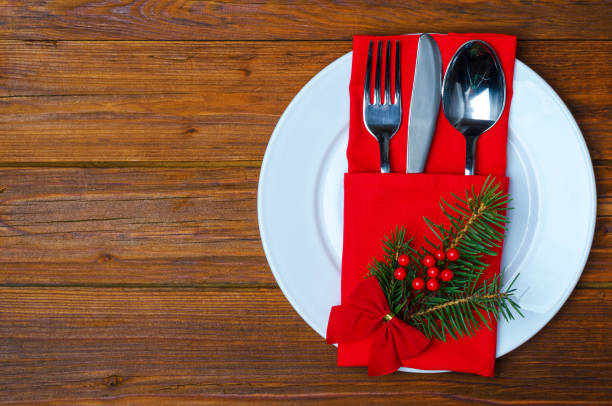 istock Christmas plate and appliances on a wooden table top view with copy space. 881818280