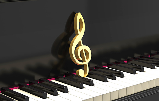 Golden treble clef on the classical piano keyboard (3d illustration).