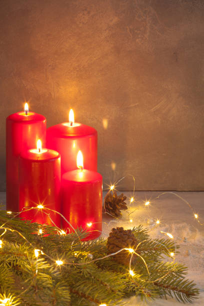 istock Red Advent Burning Christmas candles with sparkling garland 881824304