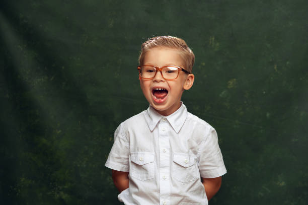 istock Funny boy in formal clothes and glasses screams 881831716