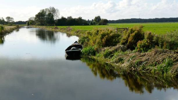 istock Landscape with small river and old boat 881834604