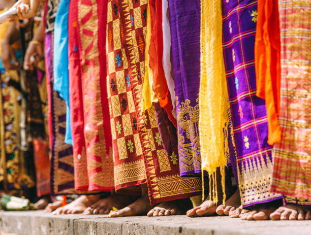 Balinese women dancers in traditional costumes Group of Balinese people in traditional costumes standing on street parade at art and culture festival. sarong stock pictures, royalty-free photos & images