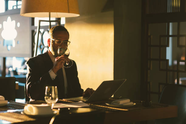 Mature Businessman Working in High-End Restaurant