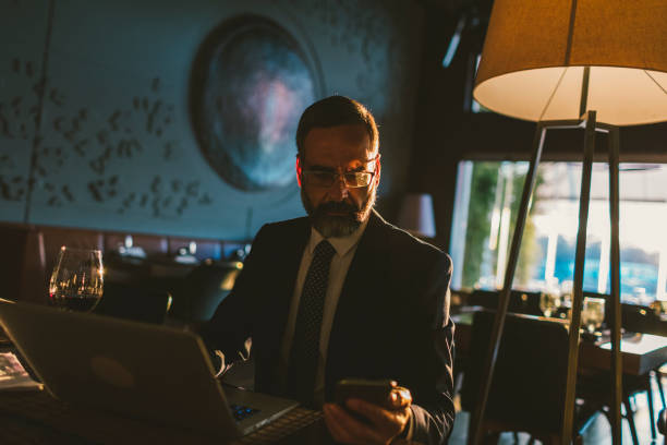 istock Mature Businessman Working in High-End Restaurant 881838120