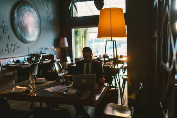 istock Mature Businessman Working in High-End Restaurant 881839072