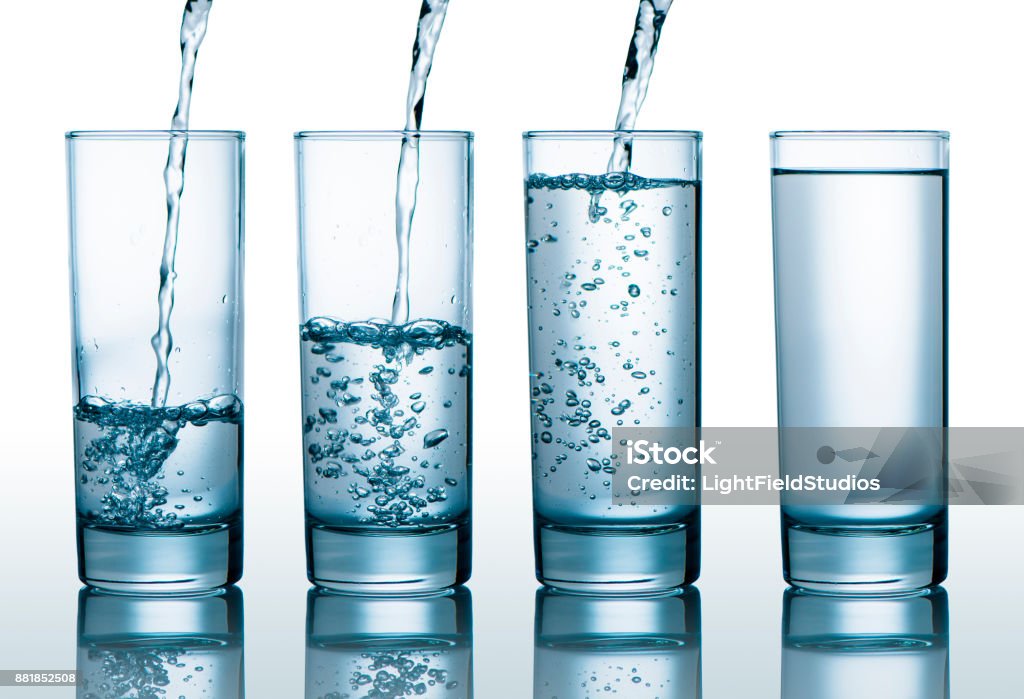 glasses with different level of water Transparent glasses with different level of water, pouring water into glasses Water Stock Photo