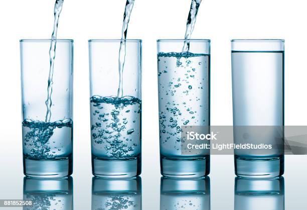 Glasses With Different Level Of Water Stock Photo - Download Image Now - Water, Drinking Glass, Pouring