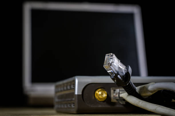 istock Network hub and rj45 cables on the stage. Computer accessories used in networking. 881852618