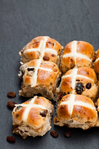 istock Easter  cross buns and sultanas on black stone background 881853454
