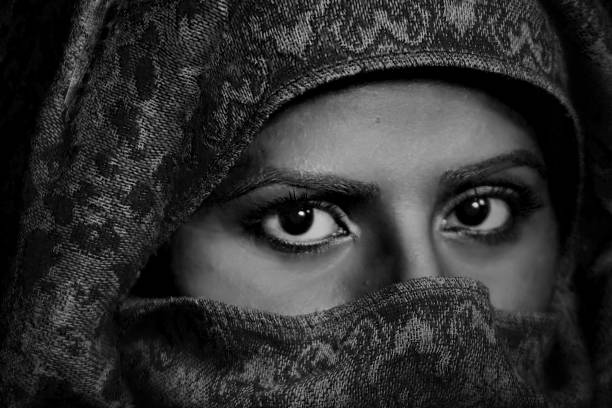 istock woman with headscarf close-up black and white 881860108