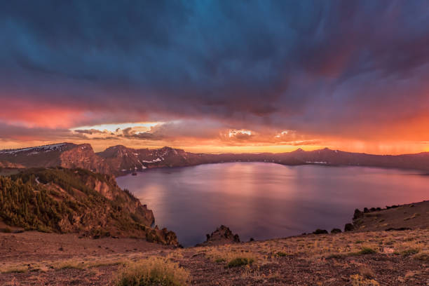 istock Orange Sunset and Storm Clouds Over Crater Lake 881864718