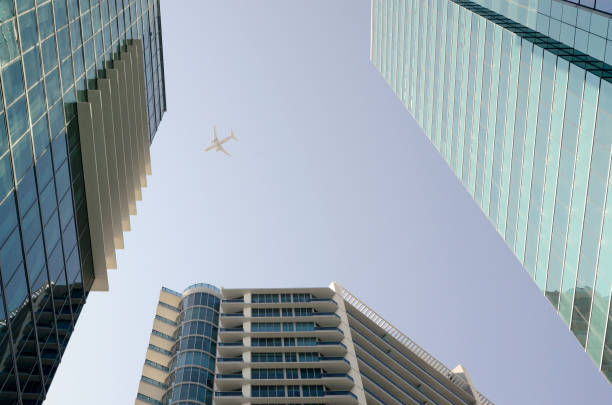 istock Commercial Jet Airplane Over Office Buildings 881865356