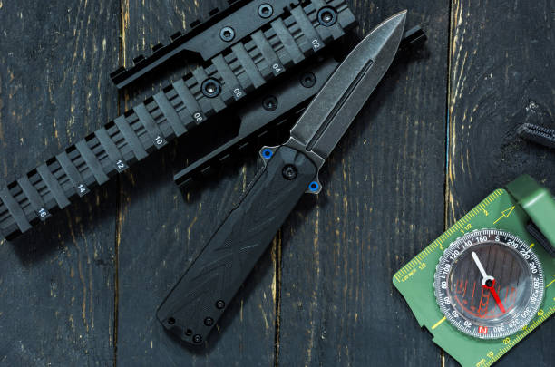 istock Knife, compass and picatiny rail. Military composition. Wooden background. 881867940